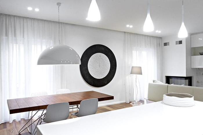 This renovated apartment in Italy with open-space interior boasts elegant black and white palette and custom cabinets