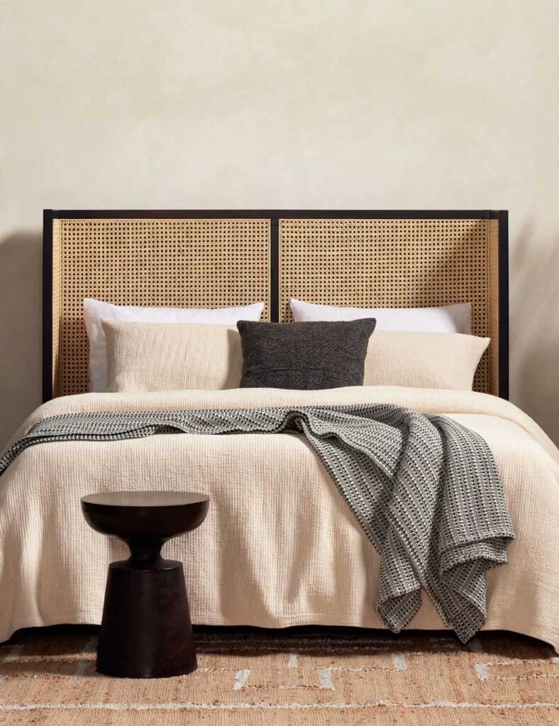 Wood bed frame and cane paneled headboard for a timeless bedroom look