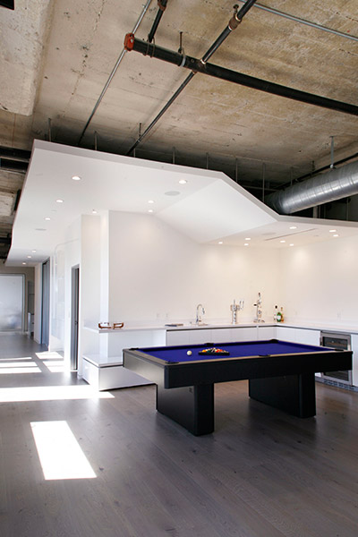 Pool table in modern twin loft in Los Angeles by CHA:COL