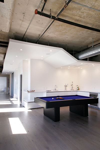 Pool table in modern twin loft in Los Angeles by CHA:COL