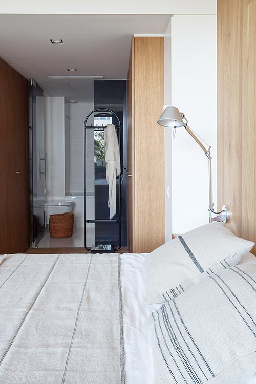 Modern bedroom design & small bathroom in a confortable renovated apartment located in Barcelona, Spain