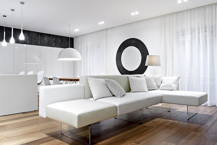 Modern living room design idea with beautiful white sofa in a renovated apartment located in Italy