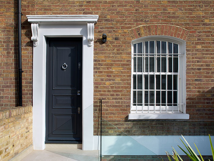 Entrance of a renovated 1800s brick cottage in London by extrArchitecture