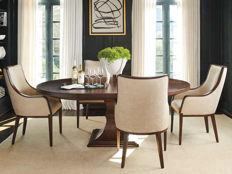 Round dining table extended with a 22-inch leaf to oval to accommodate up to six guests