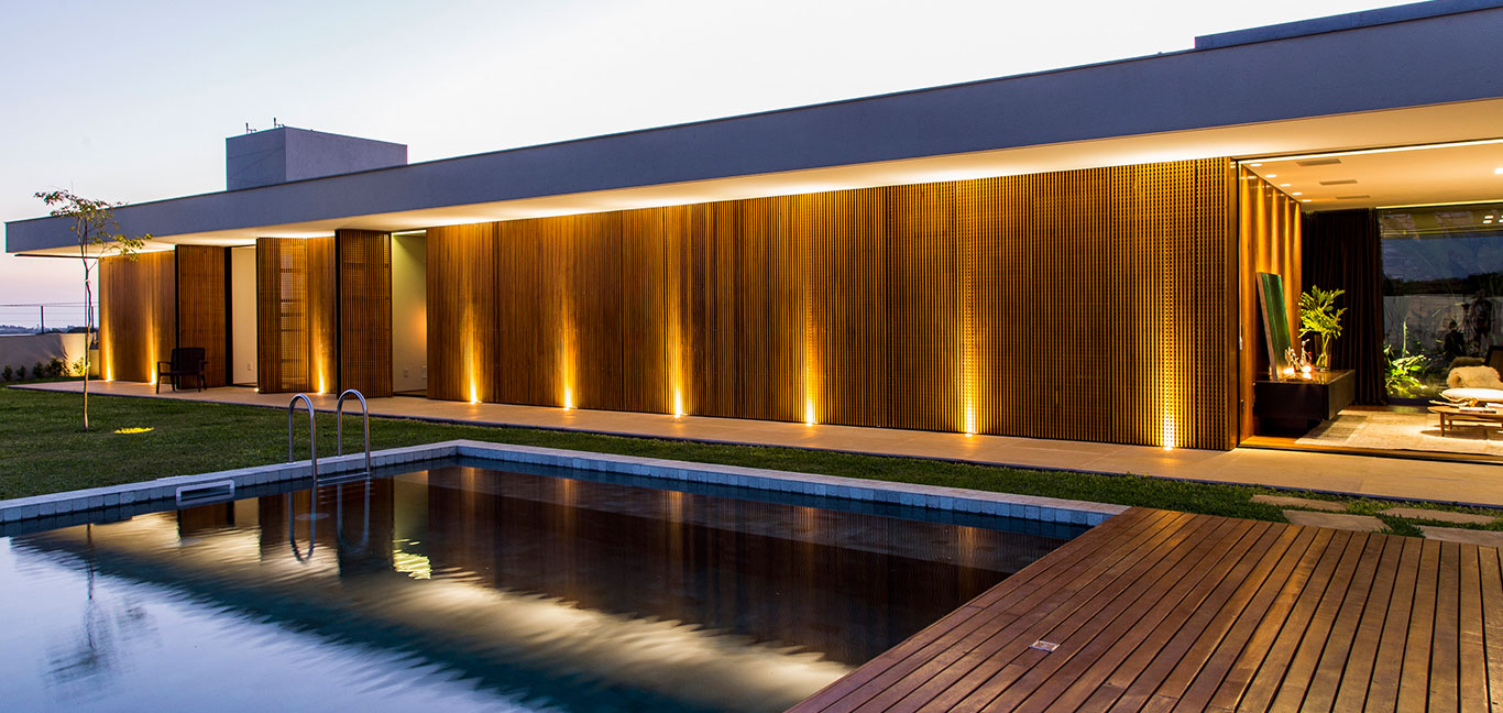 This wooden and concrete single-family house with stunning pool, located near Sao Paulo, was inspired by Brazilian modernism