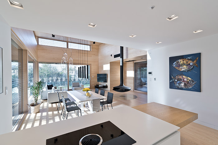 View of living room from open space kitchen area - inside single-storey house in Poland entitled Cedar House