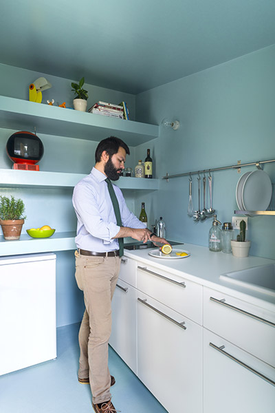 Functional small turquoise blue kitchen in small 28 square meter apartment in Milan, Italy by Studio WOK