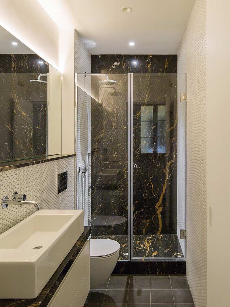 How to make a small bathroom look bigger - glass panel instead of shower curtain