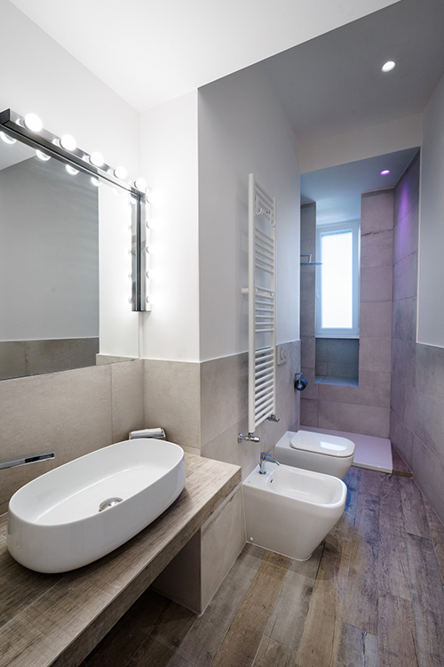 Small bathroom design idea in an all-white minimalist apartment in Rome, Italy
