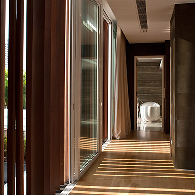 Unique hallway design idea leading to white bathroom in a spacious contemporary house in Singapore