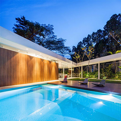 Spectacular house in Sao Paulo lets the family sunbathe on the patio and swim in the gorgeous LED light swimming pool - designed by FGMF Architects