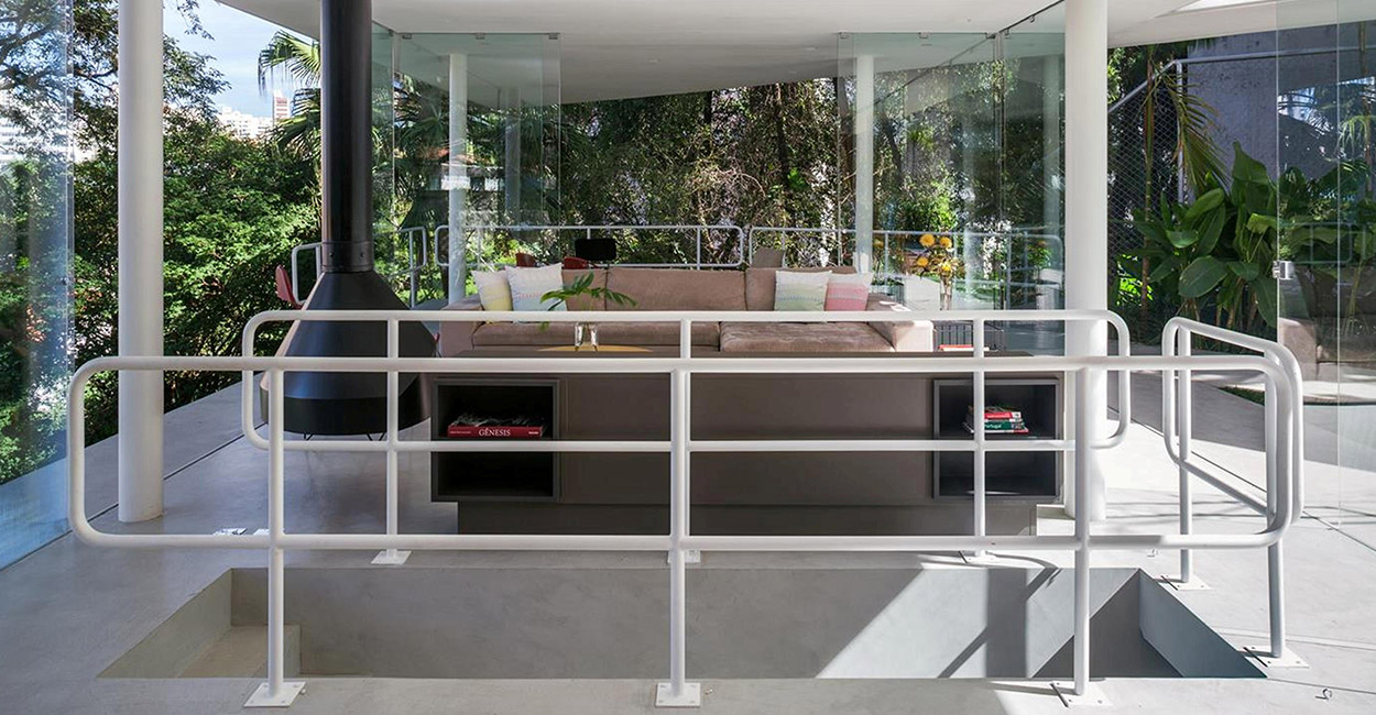 Lots of glazing makes this open plan living room have spectacular views of the garden and outdoor patio with pool -spectacular house in Sao Paulo, Brazil