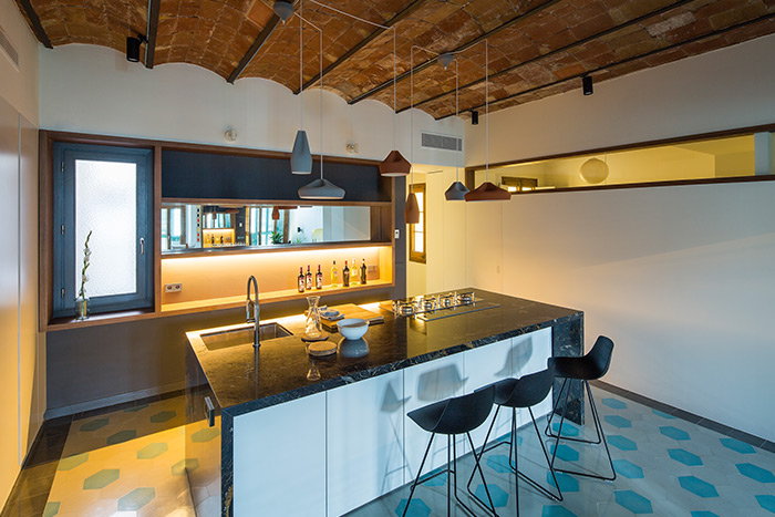 Gorgeous kitchen design idea in a stunning apartment in Barcelona that uses mirrors to amplify space and light - by Nook Architects