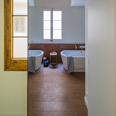 Bathroom design idea in a stunning apartment in Barcelona that uses mirrors to amplify space and light - designed by Nook Architects