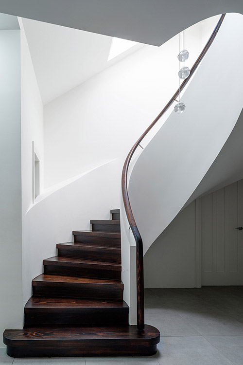 Modern spiral staircase in a stunning dwelling composed of 2 apartments located in Sydney, Australia