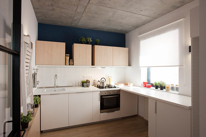 Stylish white kitchen in modern apartment in Bucharest, Romania for two architecture and design lovers