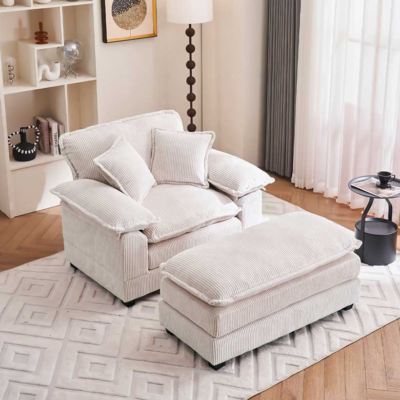 White upholstered corduroy armchair with ottoman