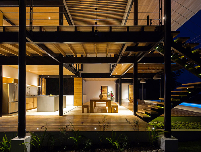 Wood is used throughout the open-space interior of this eco-friendly house in Costa Rica with breathtaking views of the ocean and jungle